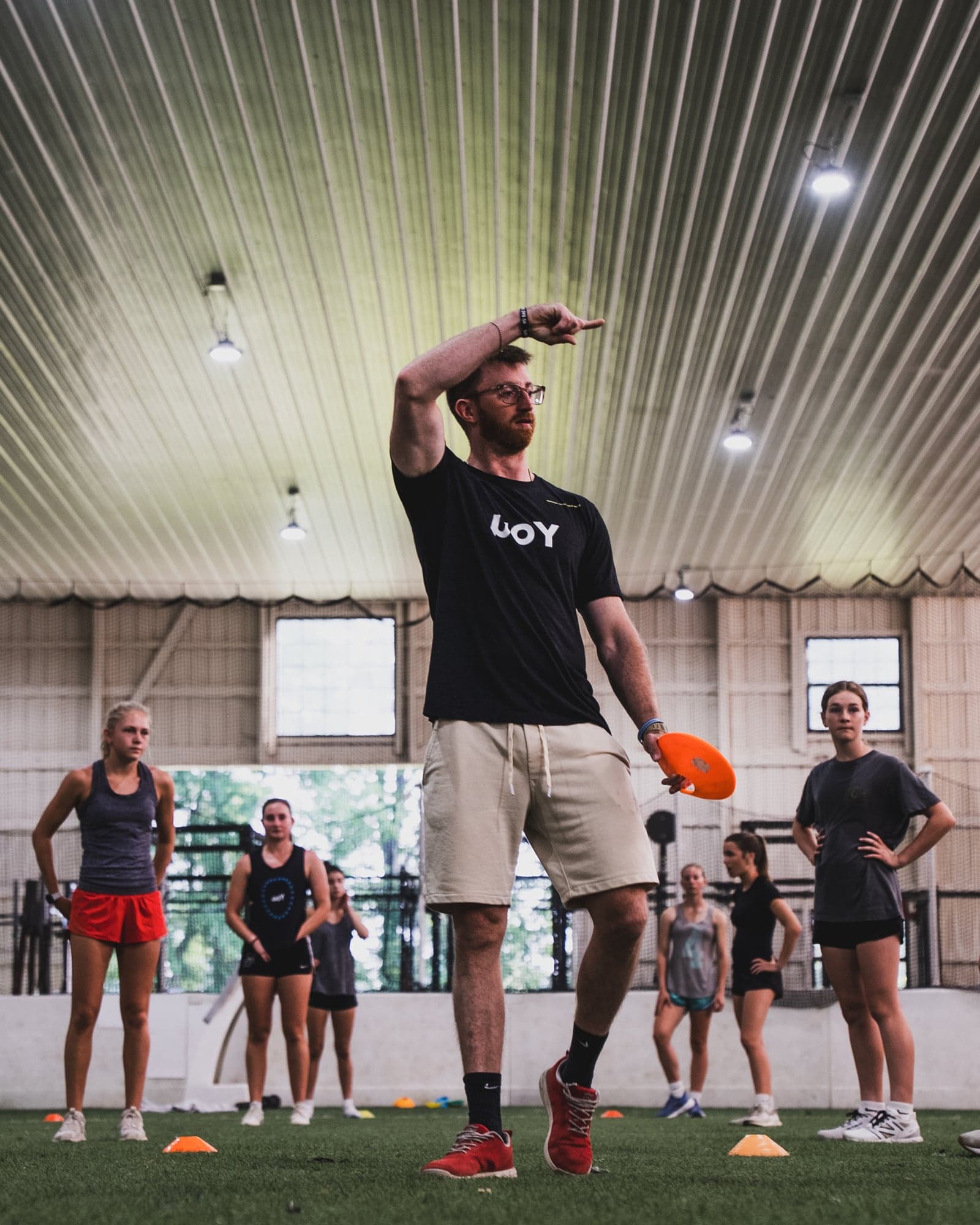 Coach directing players during an indoor training session